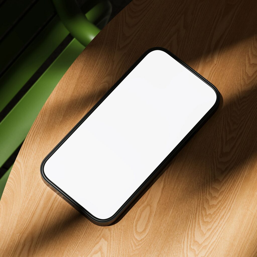 Smartphone with blank white screen mockup on wooden table in sunlight, concept template for app display or UI design presentation use. 3D Rendering