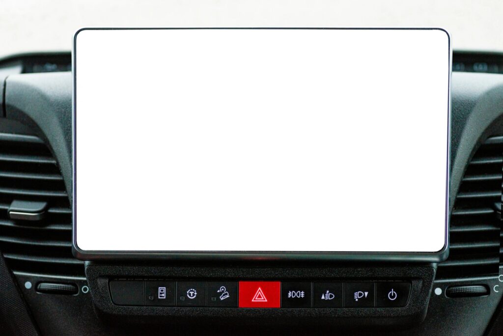 Large blank white touchscreen display on car dashboard