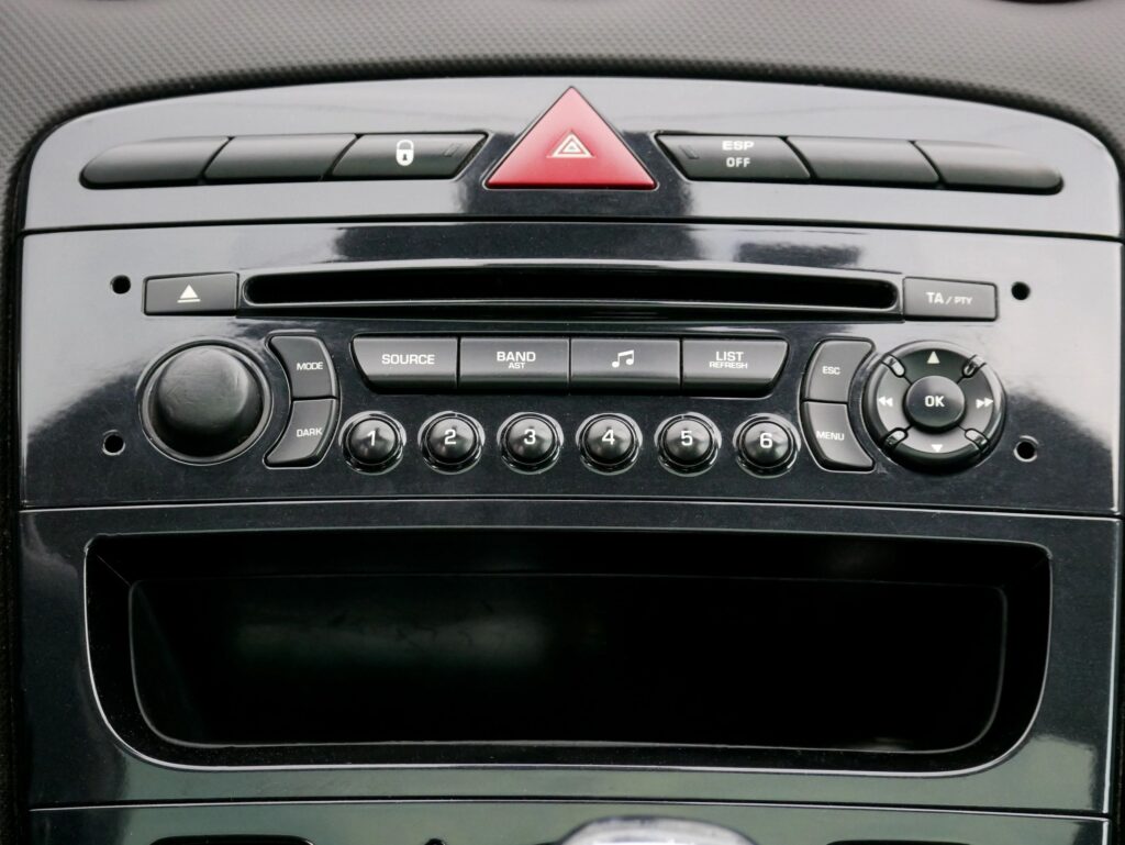 Car radio console interface with buttons and volume control. Vehicle dashboard audio system panel design element for interior technology, transportation engineering and automobile travel.